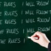 Blackboard writing that says I will follow rules